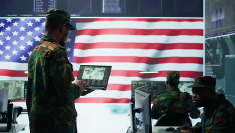 us soldiers operating in a high tech cybersecurity command post