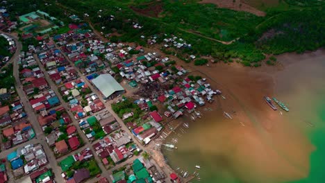 Aerial-view-of-Placer,-Surigao-del-Norte,-Philippines-over-muddy-water