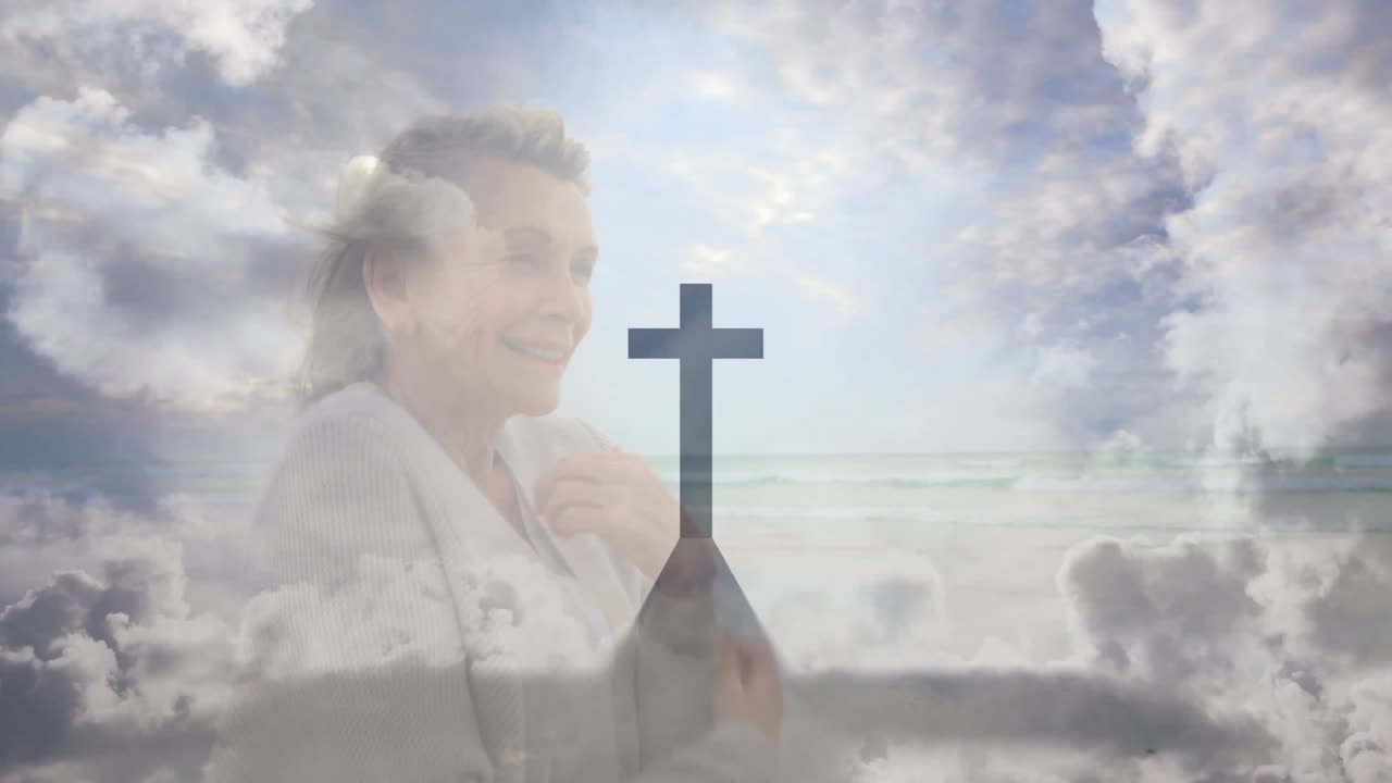 Senior woman raising hand, moving hand head-to-chest, seeking faith amid seascape-cross overlay