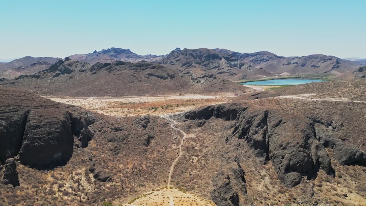 Desert landscape with mountains in the distance, dry terrain in La Paz, Mexico