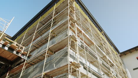 building with scaffolding against a clear blue sky