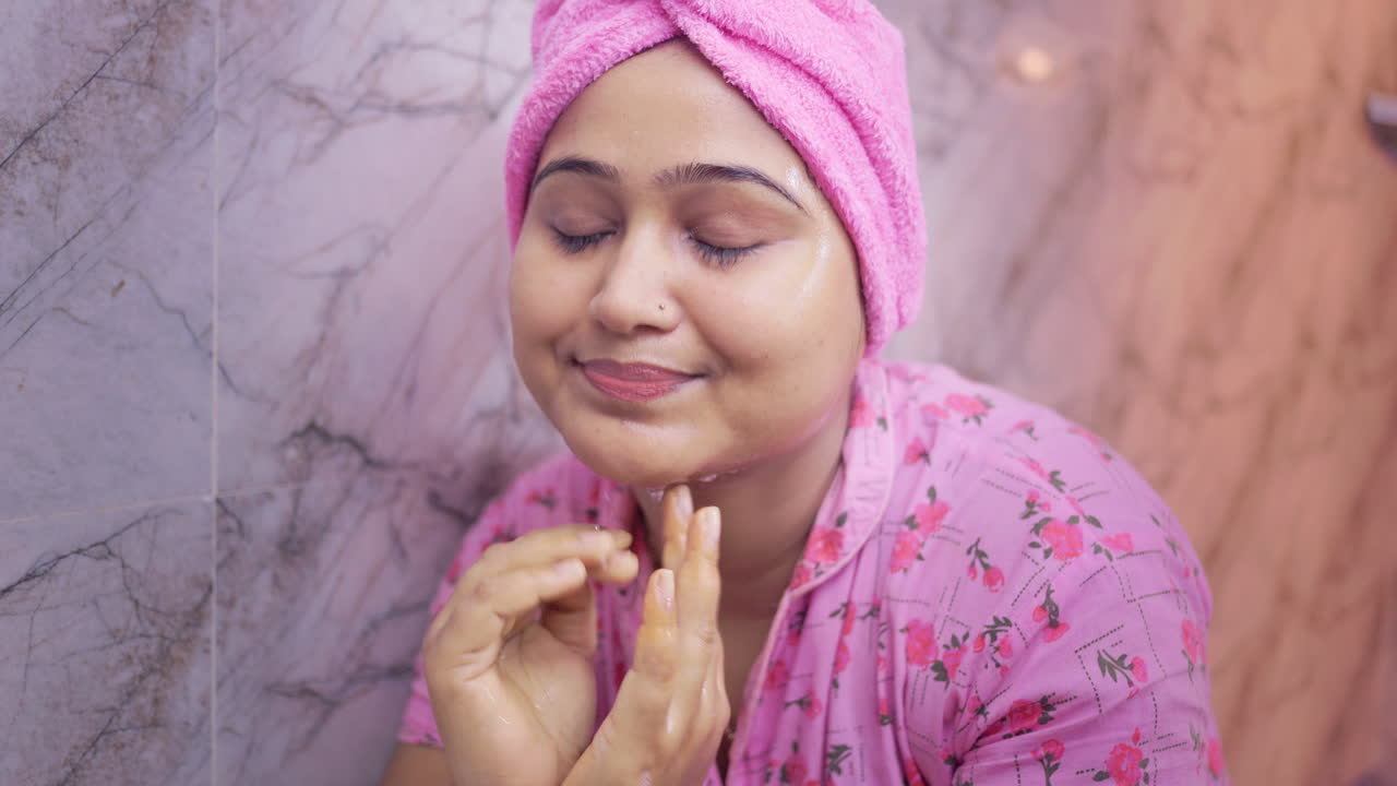 Indian woman washing her face with normal water in the bathroom, personal hygiene and skincare concept