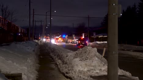 removing snow from suburban streets at night in ottawa with snow plows and blowers.