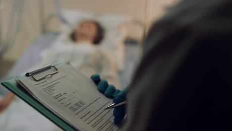 closeup medical clipboard in doctor hands. therapist checking patient history.