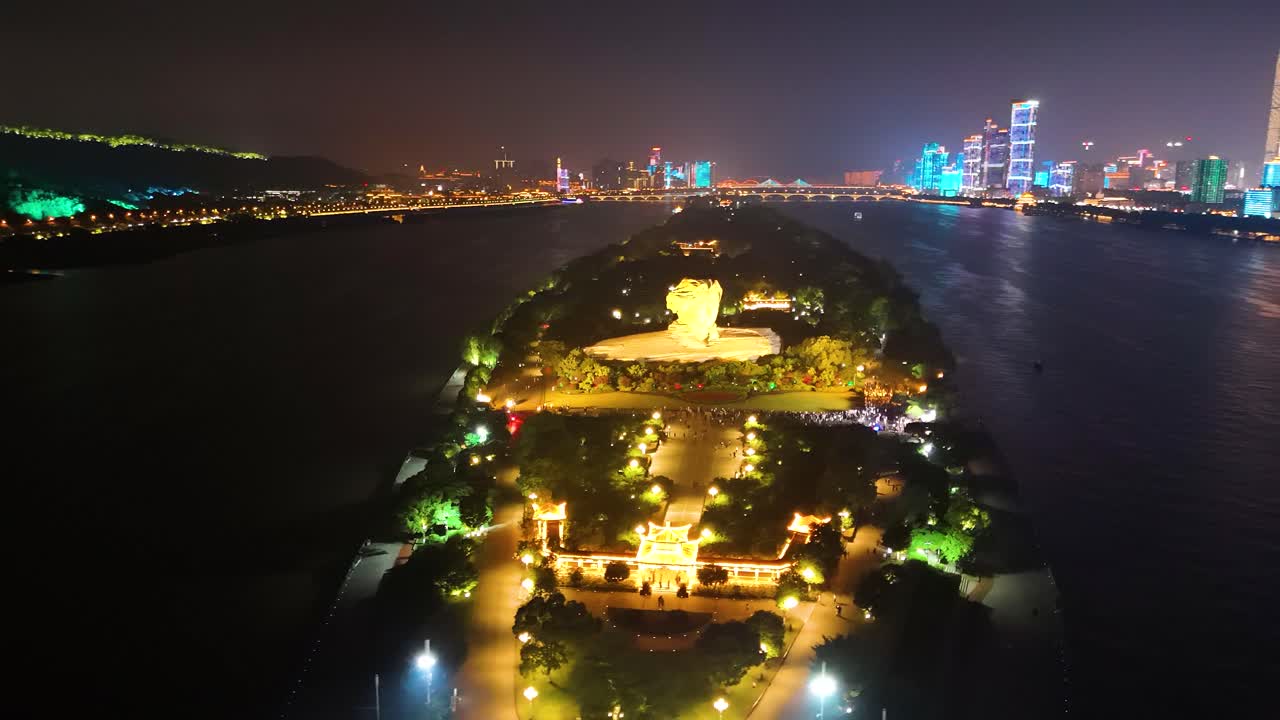 vista nocturna de la órbita del parque de la isla naranja con la estatua del joven mao zedong en la ciudad de changsha, hunan, china