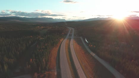 slow zoom out to the highway, with the sky and the sun in the background.