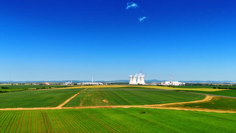 modern industrial plant working in the countryside. white smoke rises into the air from the huge pipes. aerial view