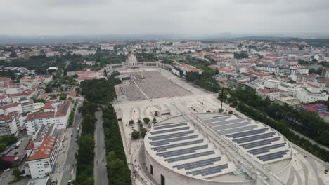 Fátima-showing-the-sanctuary-and-surrounding-cityscape-on-a-cloudy-day,-aerial-view