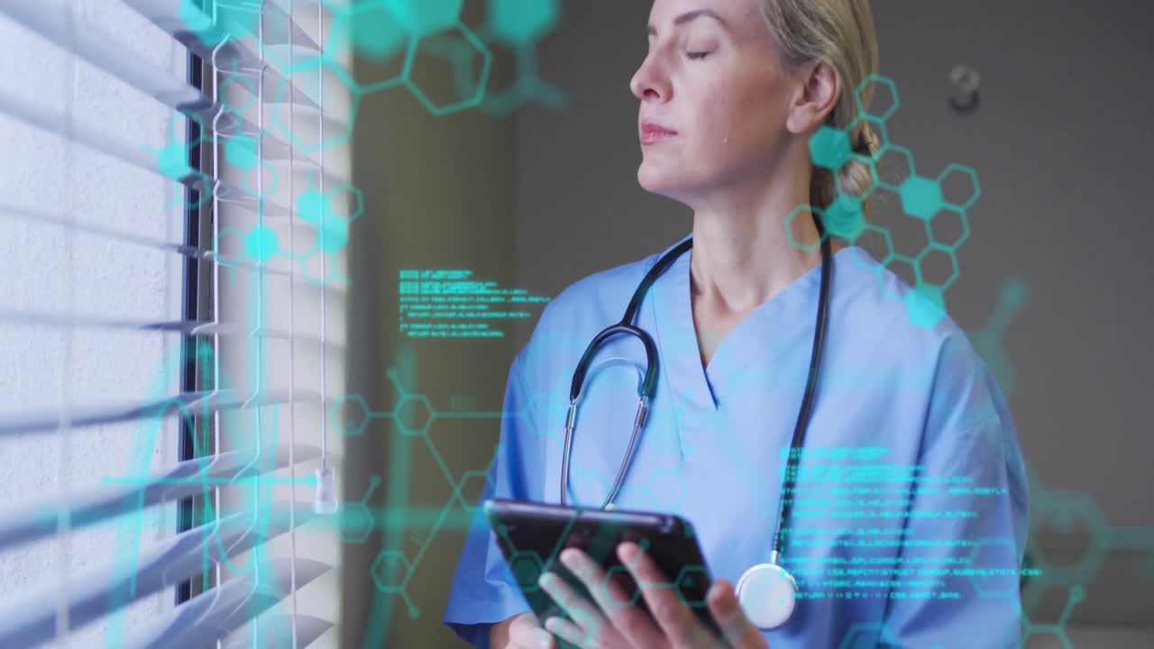 Holding tablet with digital data, healthcare professional in scrubs in hospital