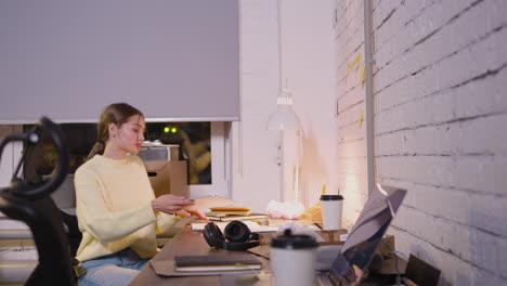 female employee sitting in office chair and using tablet