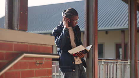 teenage student reading a book on school campus