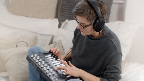 person playing midi keyboard at home