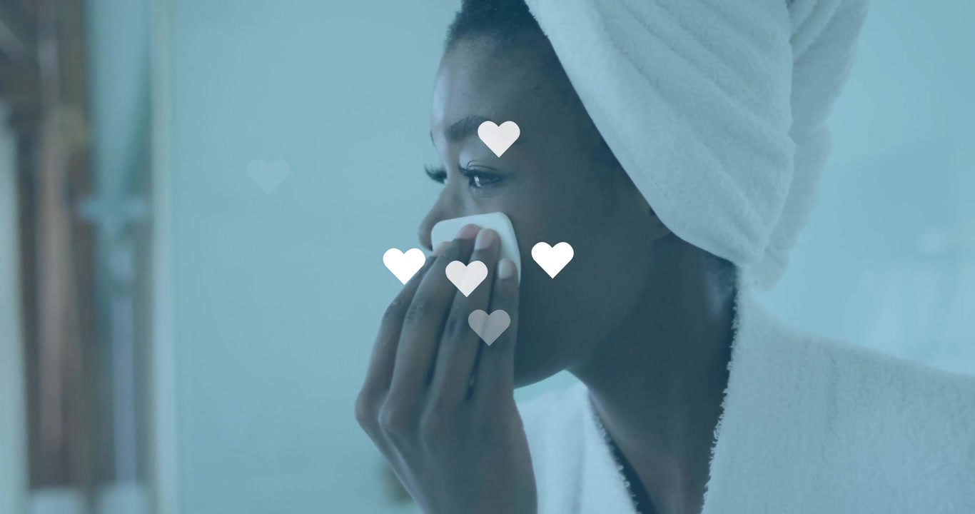 woman lifting pad to cheek at bathroom mirror, with animated hearts highlighting skincare routine