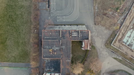 aerial view of an abandoned school and surrounding grounds