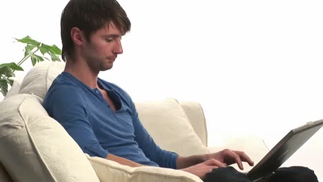 Attractive-Man-on-Sofa-on-the-Laptop