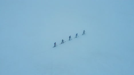 skiers on the glacier climb the silvretta mountains in switzerland