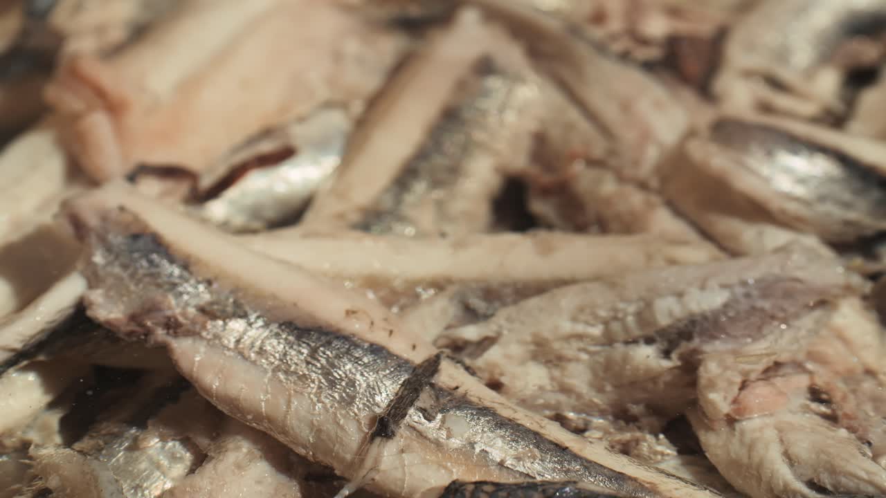 Fresh Sea sardines and Anchovy Fish and Mullus On Display On Ice On Market Store Shop. Seafood Fish Background, close up stand of small salty white fish.