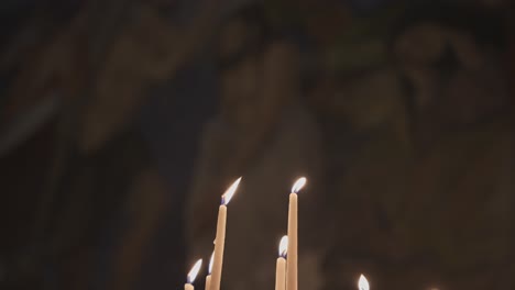 Candles-shining-and-oscillating-in-Church