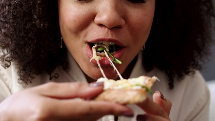 Woman eating pizza