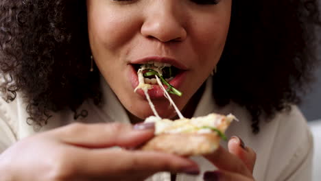 woman eating pizza