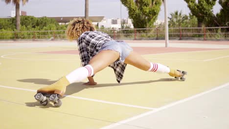 fun young woman doing the splits on skates