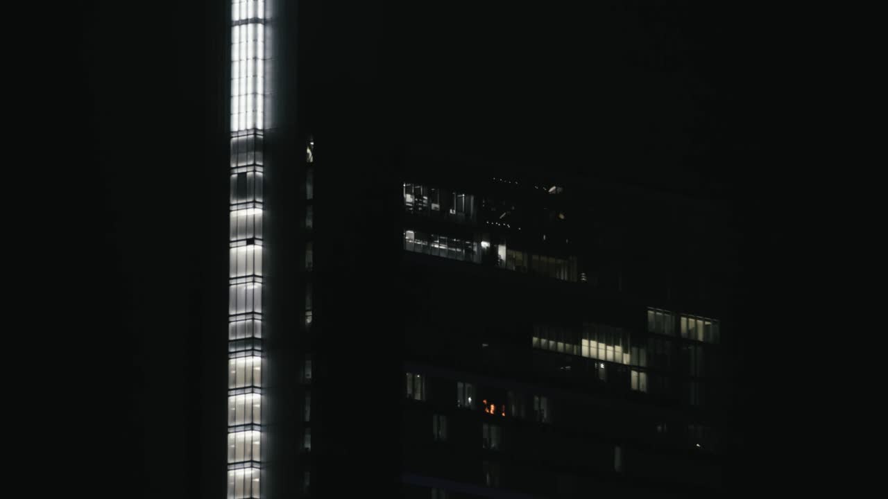 Philadelphia skyline, at night, with buildings, lights, and reflections