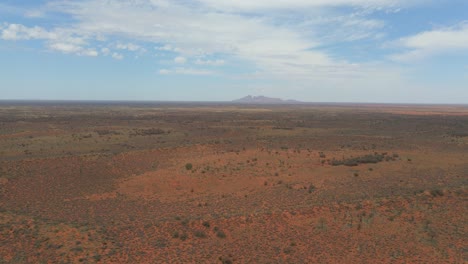 deserted outback landscape under blue sky with cloudscape at uluru, ayers rock in northern territory, australia