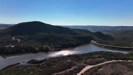 slow motion aerial drone shot of calavera hills on a summer day with lake in view