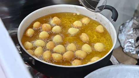 a traditional arab sweet called al logimat is being prepared