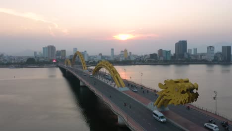 colorful aerial of dragon bridge cau rong, traffic and city skyline during sunset in danang, vietnam