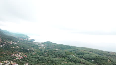 FPV-drone-flying-over-tropical-island-towards-the-sea-on-a-cloudy-day