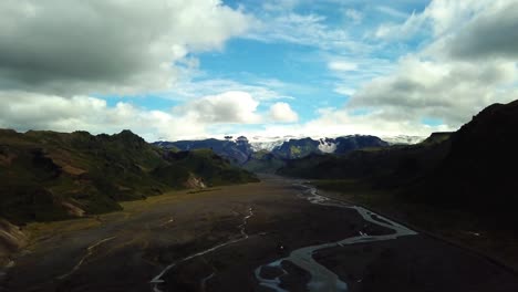 Aerial-landscape-view-of-a-river-flowing-through-a-valley,-in-Fimmvörðuháls-area,-Iceland