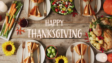 Animation-of-happy-thanksgiving-over-dinner-food-on-wooden-background