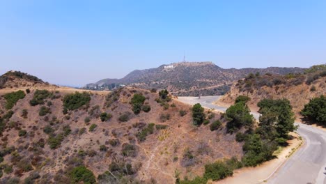 Aerial-Along-Mulholland-Drive-Or-Griffith-Park-Reveals-Hollywood-Sign-In-Distance-Los-Angeles-California