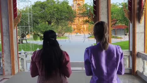 two women visiting a thai temple