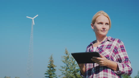 a young female farmer uses a tablet in a field technology in agriculture