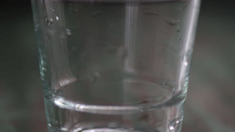 close-up pouring water into a glass