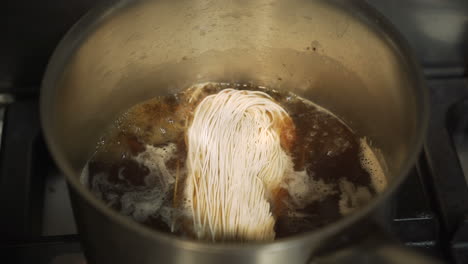 noodles being cooked in a pot