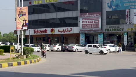 a prominent commercial building is prominently positioned along the main road, with a row of parked cars in the front.