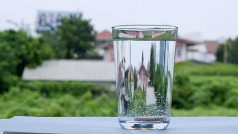 dropping a tablet of antacid into a glass of water that burst into tiny bubbles in the water