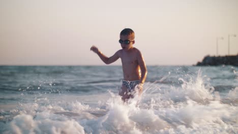 boy and splashing sea waves