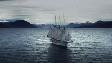 an aerial view of the old sailing ship crossing the fjord