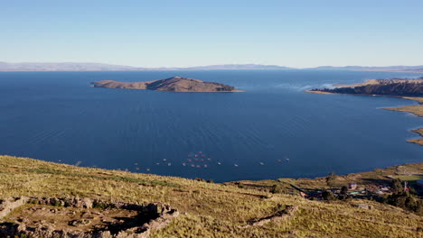 aerial shot titicaca lake bolivian side over hill ruins fishermen boats island