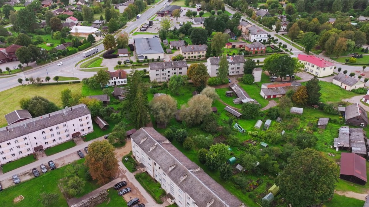 Skrunda town Latvia drone flying low and closer with tilt up, urban landscape