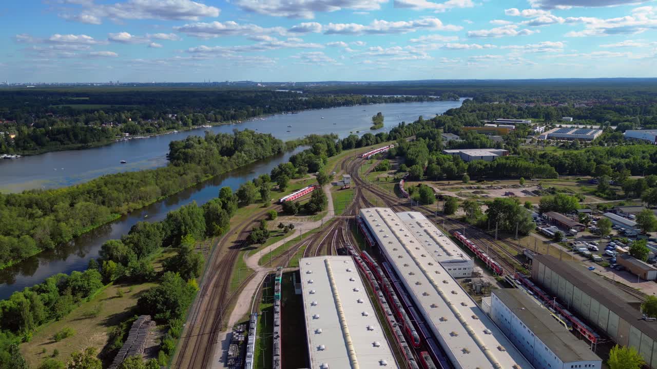 Hennigsdorf railway factory train depot overlooking the river in Brandenburg, Germany. Wonderful aerial view flight wide orbit overview drone