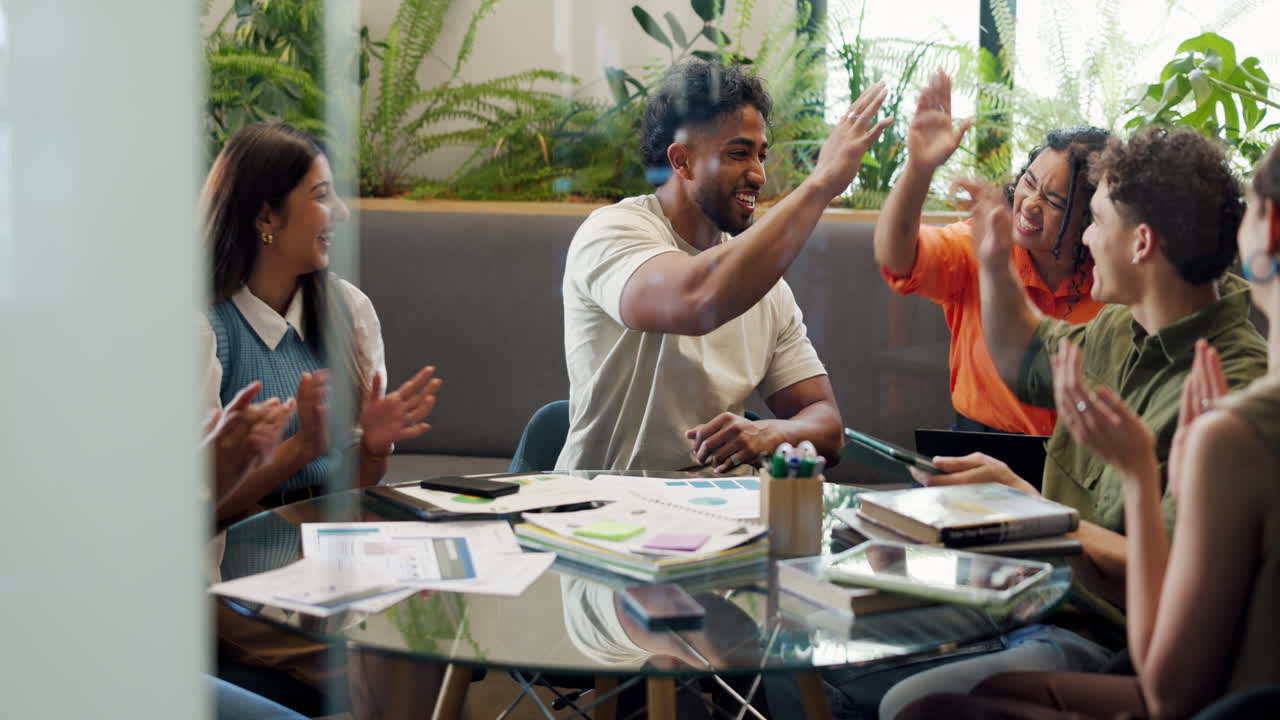 Diverse Group of Young Professionals High-Fiving and Celebrating Success