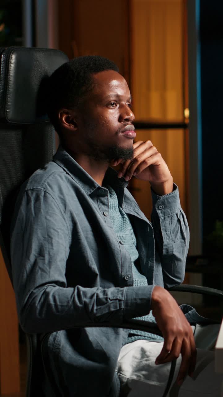 Portrait of a Smiling Black Man in an Office Chair