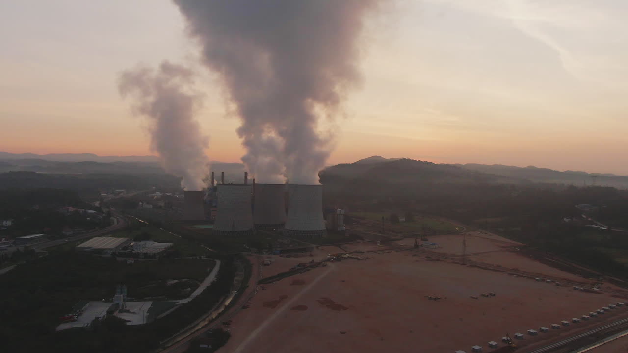 Aerial view of a power plant with smoke emissions