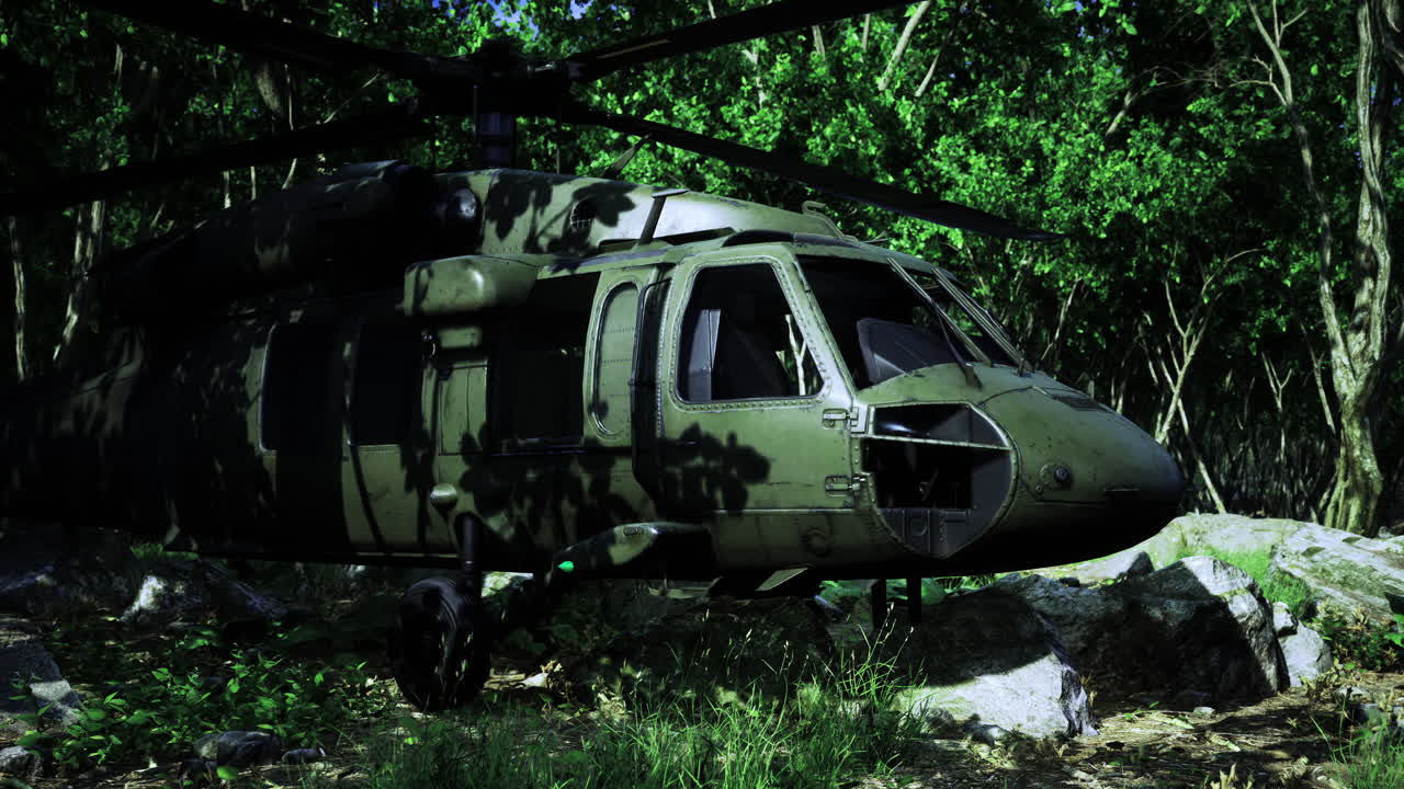 Military helicopter hovering above a lush forest landscape in daylight