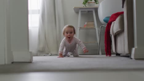 Close-up-of-caucasian-baby-crawling-on-the-floor-at-home